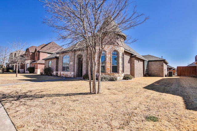 view of front of property with fence and brick siding