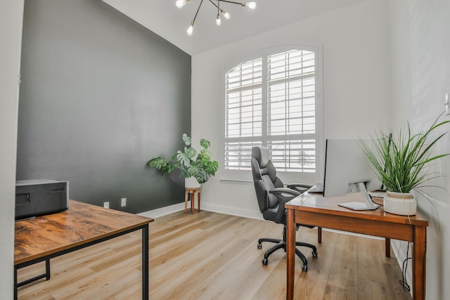 office featuring a chandelier, vaulted ceiling, baseboards, and wood finished floors