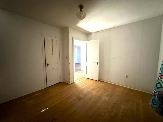 unfurnished bedroom featuring hardwood / wood-style flooring