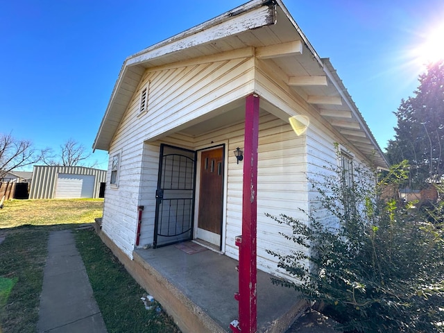 entrance to property with a lawn