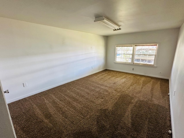 empty room featuring dark colored carpet