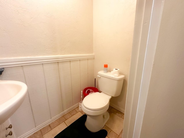 bathroom with tile patterned flooring and toilet