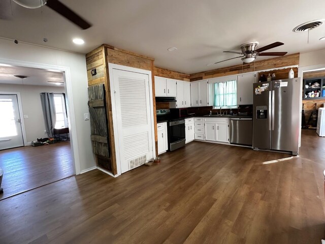 kitchen featuring sink, white cabinets, ceiling fan, stainless steel appliances, and dark wood-type flooring