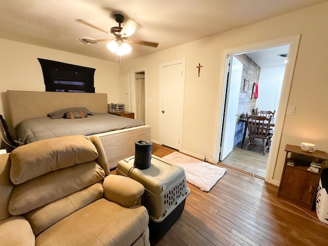 bedroom with ceiling fan and light hardwood / wood-style floors