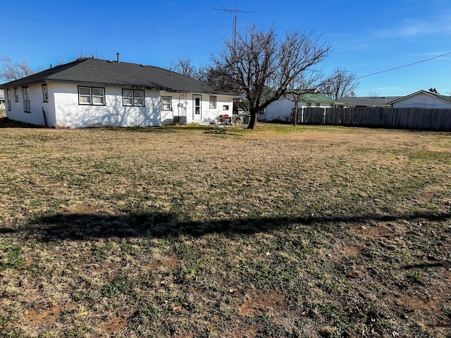 back of house featuring a lawn