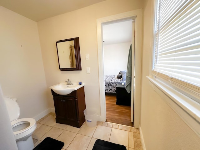 bathroom featuring tile patterned floors, toilet, and vanity