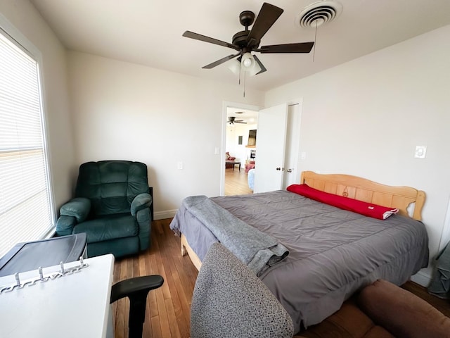 bedroom with wood-type flooring and ceiling fan