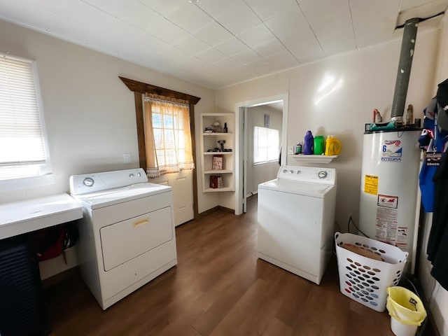 laundry area with dark wood-type flooring, independent washer and dryer, and gas water heater