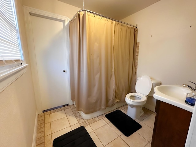 bathroom featuring vanity, tile patterned floors, and toilet