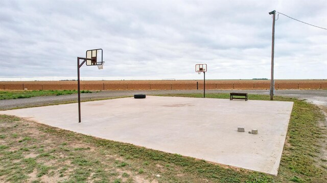 view of sport court with a rural view