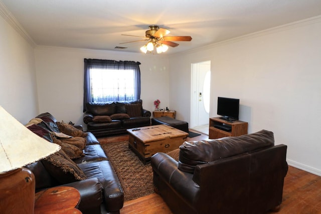 living room featuring hardwood / wood-style floors, ornamental molding, and ceiling fan