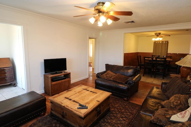 living room featuring hardwood / wood-style flooring, ornamental molding, and ceiling fan