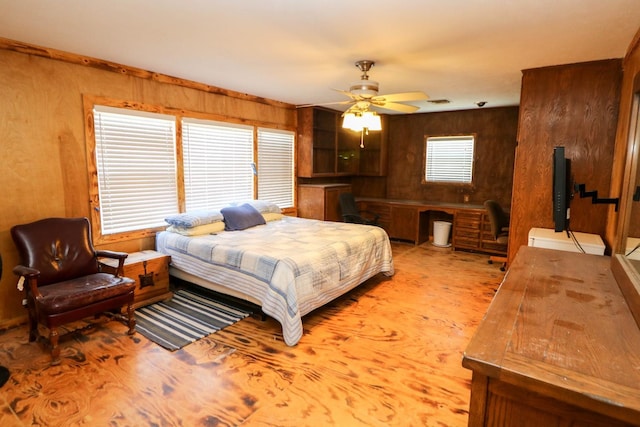 bedroom with built in desk and wood walls