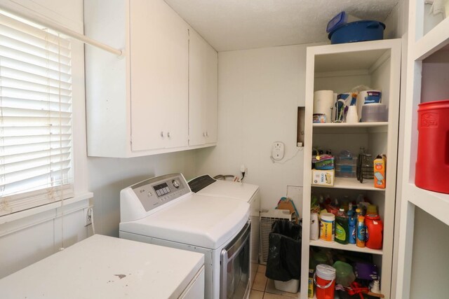 washroom with separate washer and dryer and cabinets