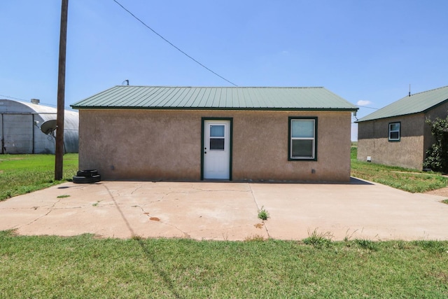 back of house featuring a yard and a patio area