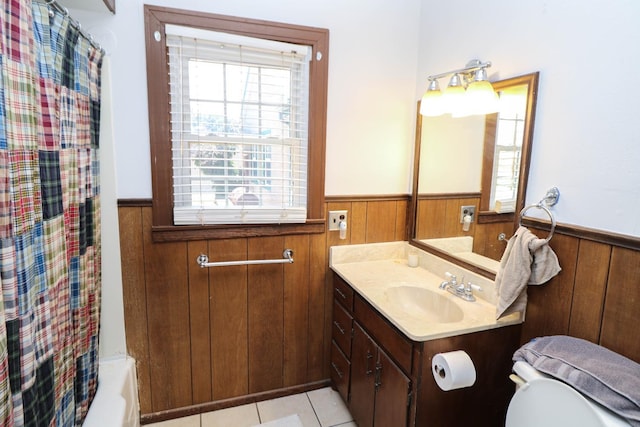 full bathroom with toilet, vanity, wooden walls, and shower / bath combo