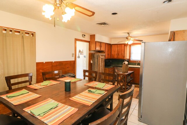 dining room with light tile patterned floors and ceiling fan