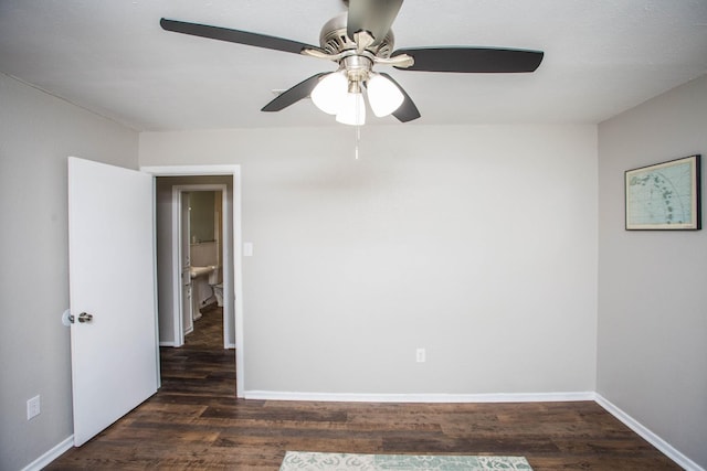 spare room with baseboards, ceiling fan, and wood finished floors
