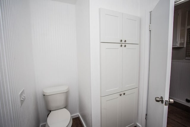 bathroom with wood finished floors and toilet
