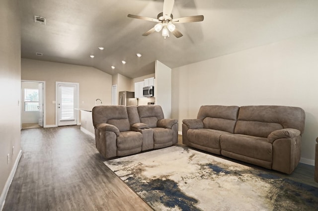 living room with ceiling fan, lofted ceiling, and dark hardwood / wood-style flooring