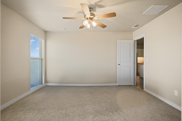 empty room featuring carpet floors and ceiling fan