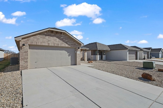 single story home with central AC unit and a garage