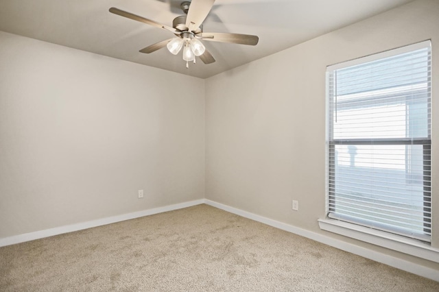 spare room featuring light carpet and ceiling fan