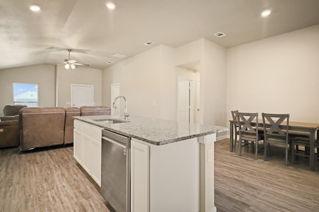 kitchen with dishwasher, an island with sink, sink, white cabinets, and light hardwood / wood-style floors