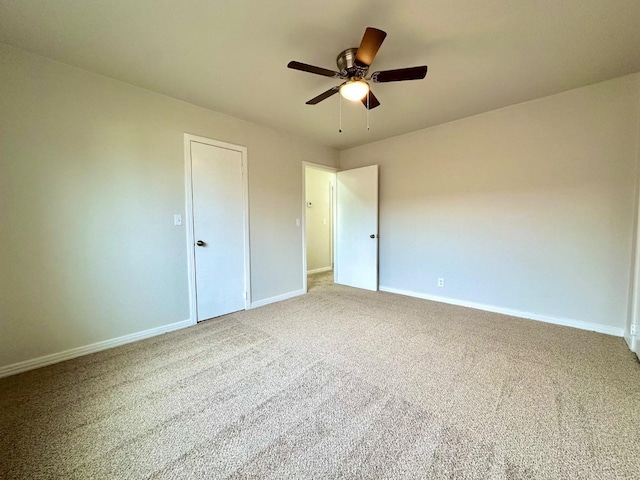 unfurnished bedroom featuring carpet, baseboards, and ceiling fan