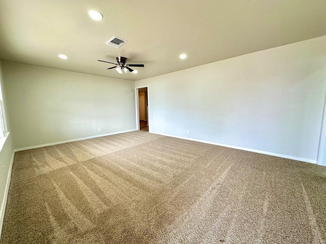 spare room featuring baseboards, visible vents, carpet flooring, and recessed lighting