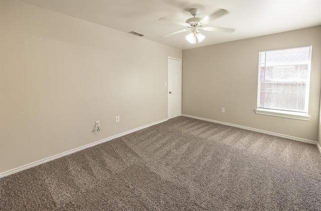 carpeted spare room with ceiling fan