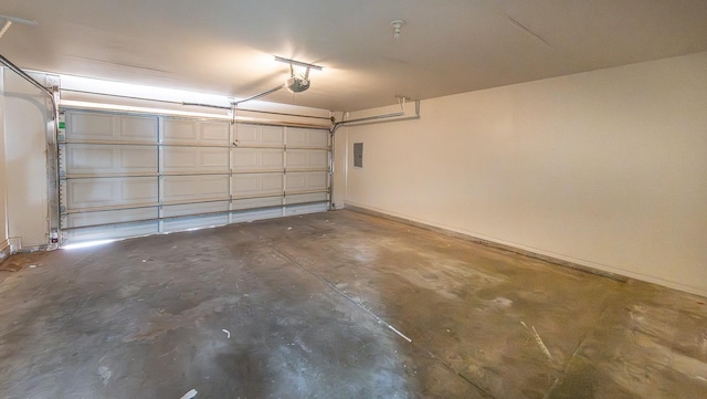 garage with a garage door opener and electric panel