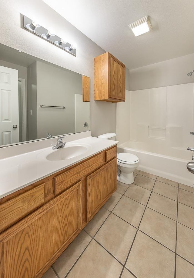 full bathroom featuring tile patterned floors, toilet, bathing tub / shower combination, and vanity