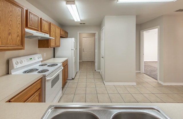 kitchen with light colored carpet and white appliances