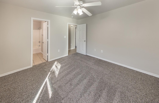 unfurnished bedroom with light colored carpet, ceiling fan, and ensuite bathroom