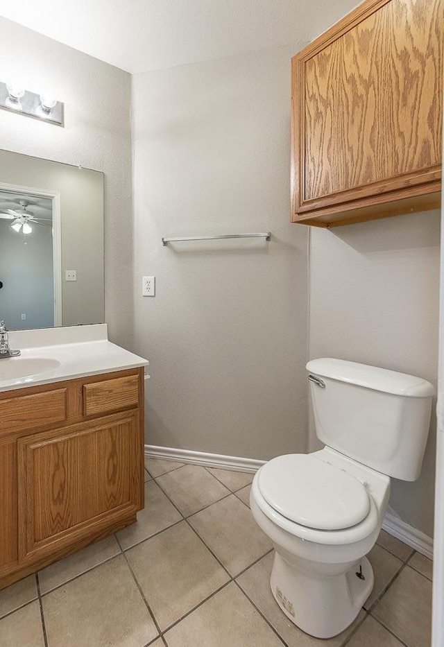 bathroom with ceiling fan, vanity, toilet, and tile patterned flooring