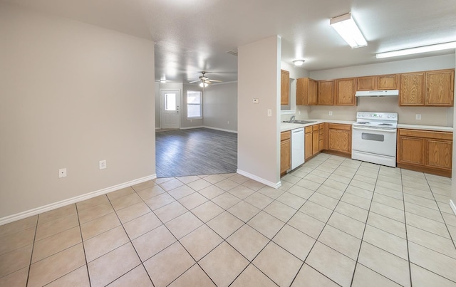 kitchen with light tile patterned flooring, white appliances, ceiling fan, and sink