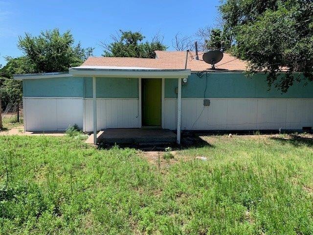 rear view of house with a yard