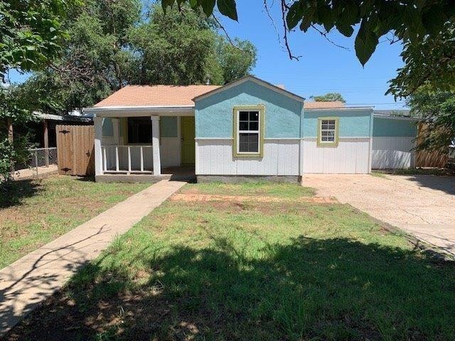 view of front of home with a porch and a front lawn