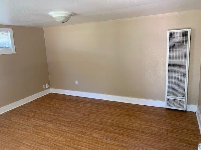 unfurnished room with dark hardwood / wood-style floors and a textured ceiling