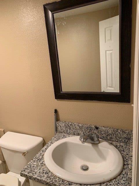 bathroom featuring vanity and toilet