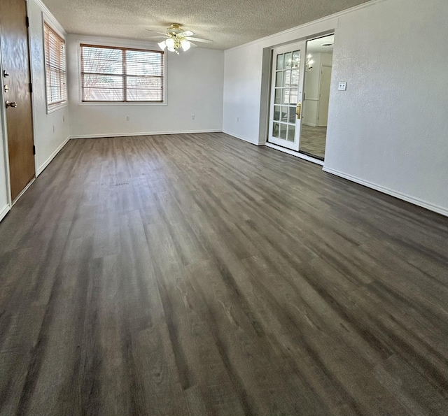 624 Tulane Ave, Big Spring, TX 79720 - empty room with a textured ceiling, a ceiling fan, dark wood-style floors, and baseboards