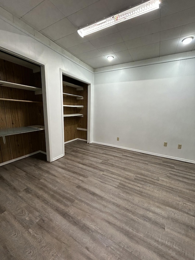 624 Tulane Ave, Big Spring, TX 79720 - unfurnished bedroom with multiple closets, wood finished floors, and baseboards
