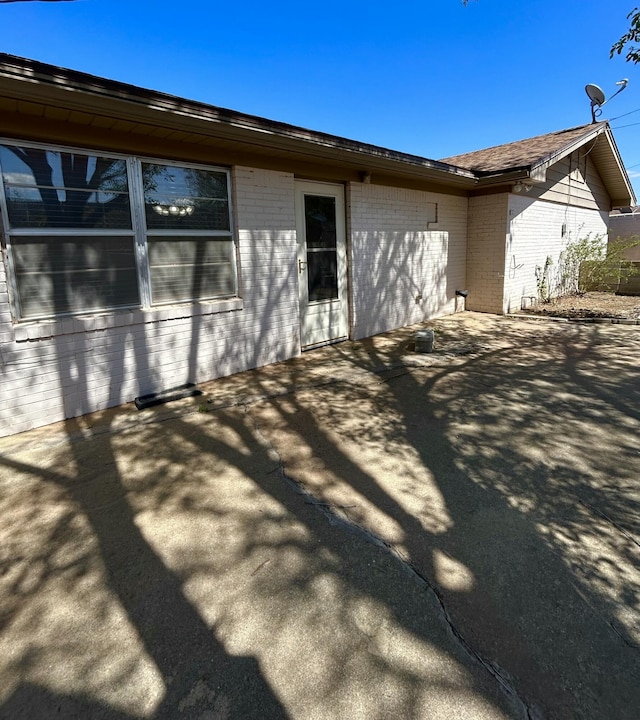 624 Tulane Ave, Big Spring, TX 79720 - view of home's exterior featuring brick siding and a patio
