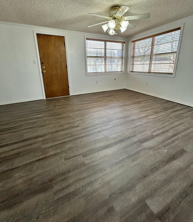 624 Tulane Ave, Big Spring, TX 79720 - unfurnished room featuring a textured ceiling, ceiling fan, healthy amount of natural light, and dark wood-style floors