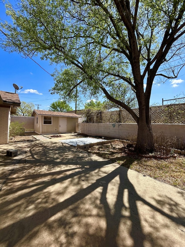624 Tulane Ave, Big Spring, TX 79720 - fenced backyard with a patio area and an outbuilding