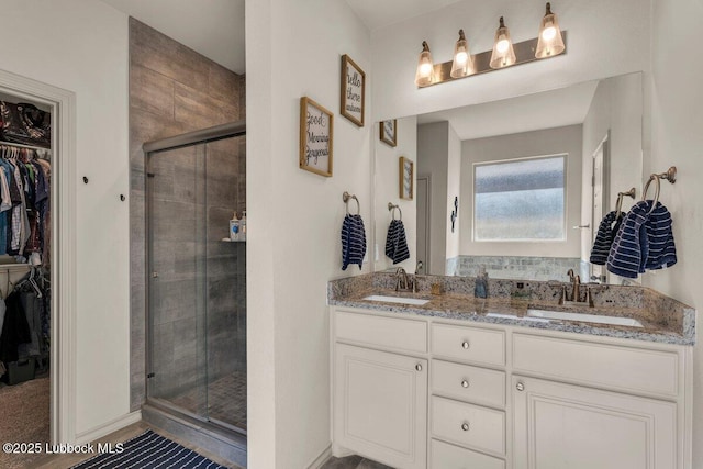 7116 23rd St, Lubbock, TX 79407 - full bathroom with a walk in closet, a shower stall, and double vanity