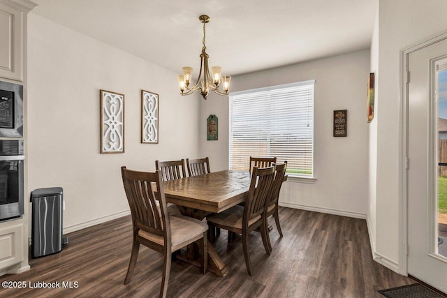 7116 23rd St, Lubbock, TX 79407 - dining room with dark wood finished floors, a chandelier, and baseboards
