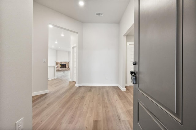 hallway with light hardwood / wood-style floors