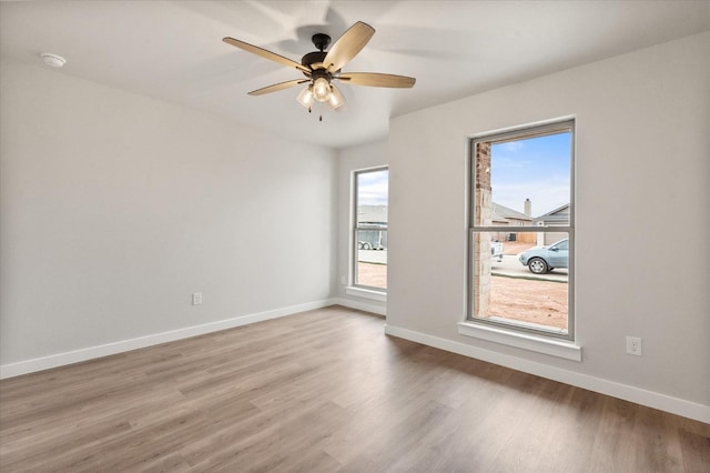 empty room with hardwood / wood-style flooring and ceiling fan